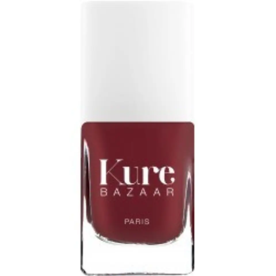 Kure Bazaar nail polish bottle, deep red colour, white cap, text "Kure Bazaar Paris".
