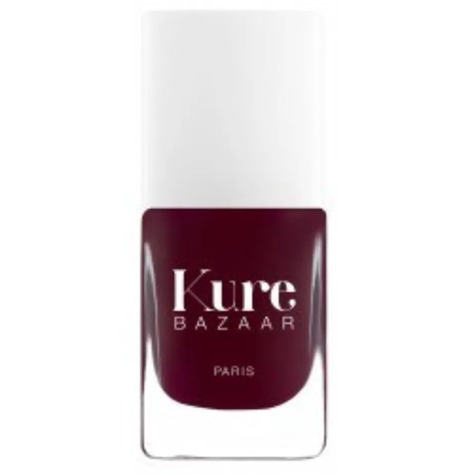 Kure Bazaar nail polish bottle, dark red colour, white cap.