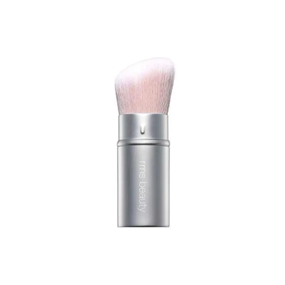 Silver makeup brush with white bristles, "rms beauty" text on handle.