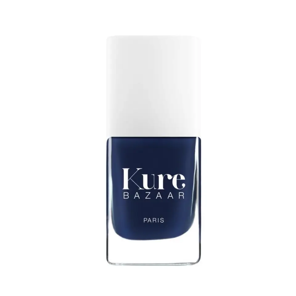 Kure Bazaar navy blue nail polish bottle with white cap.