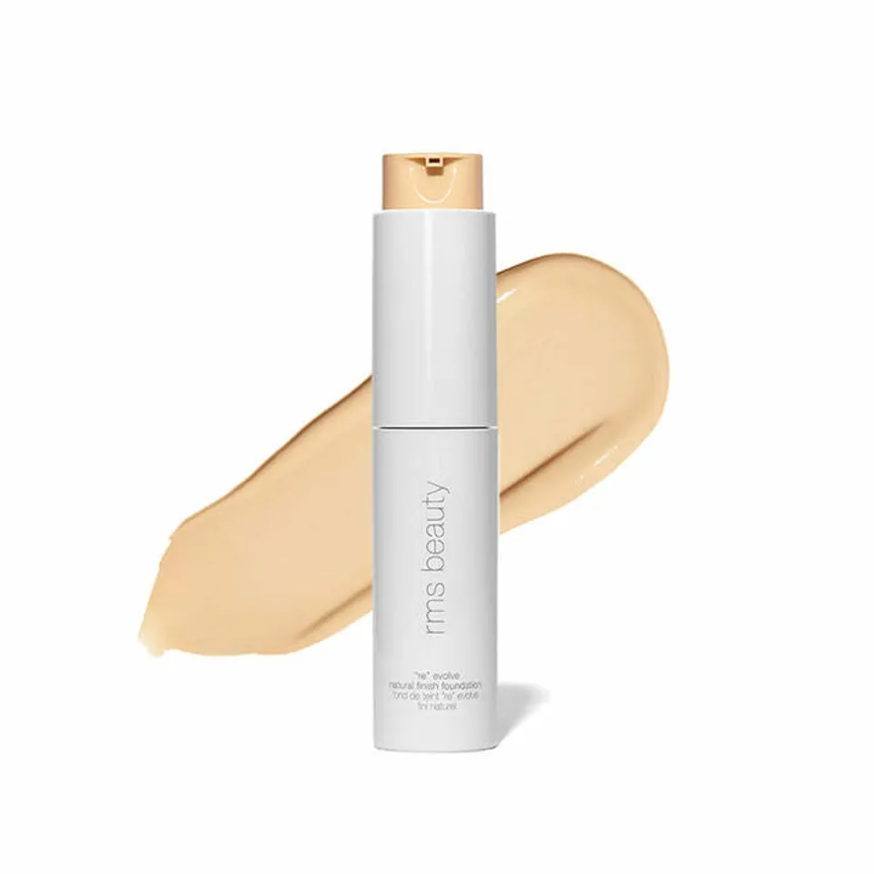 White bottle of rms beauty foundation with beige swatch behind.