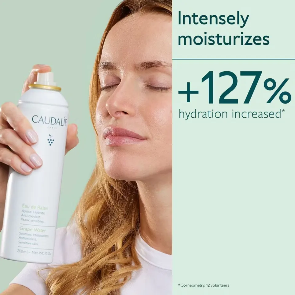 Woman using Caudalie Grape Water spray. Text: "Intensely moisturises, +127% hydration increased".