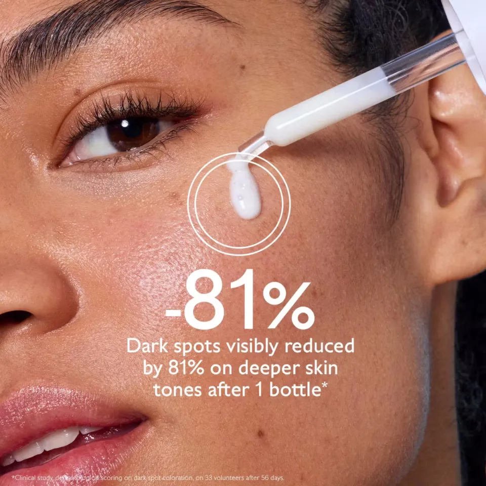 Serum dropper near woman's cheek, text: "-81% dark spots reduced on deeper skin tones after 1 bottle".