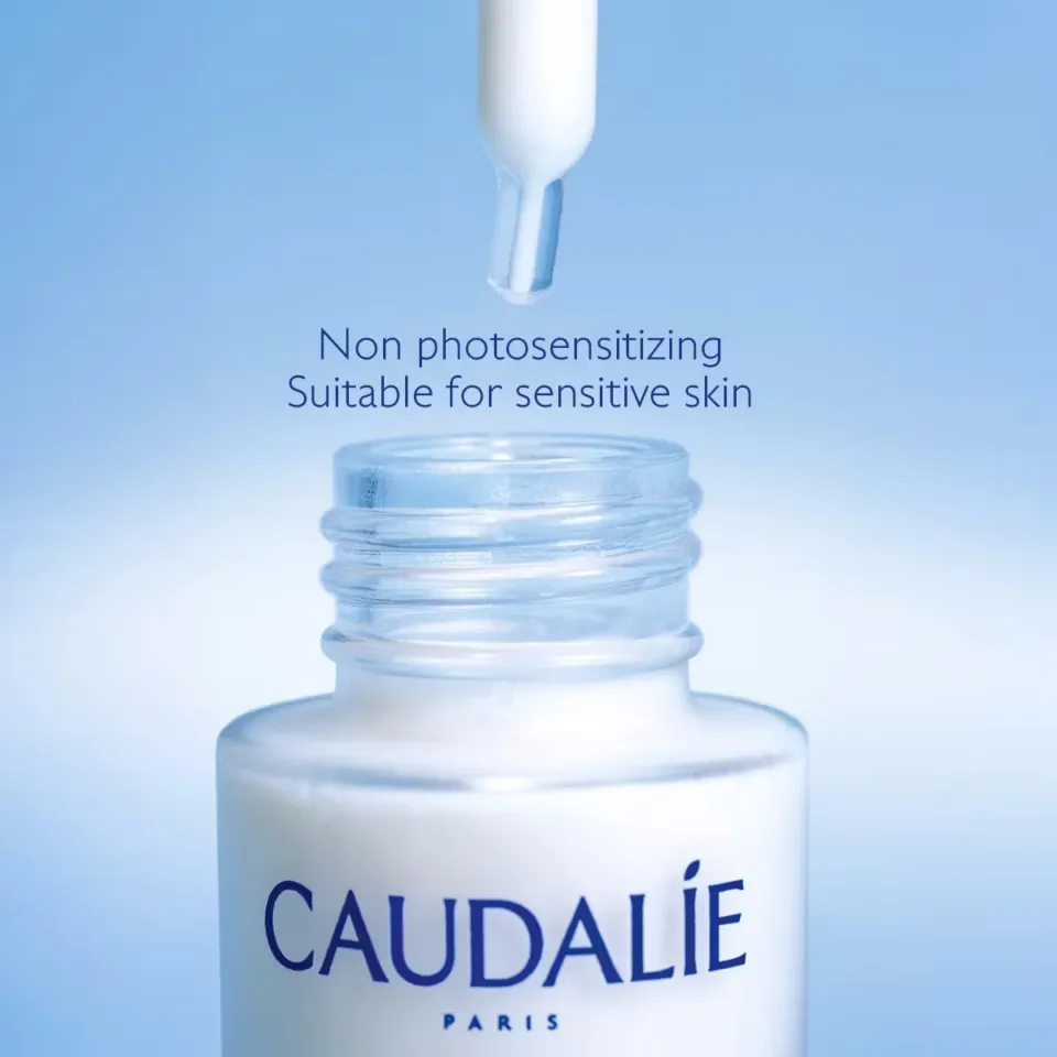 Dropper above Caudalie bottle with text: Non photosensitising, suitable for sensitive skin.