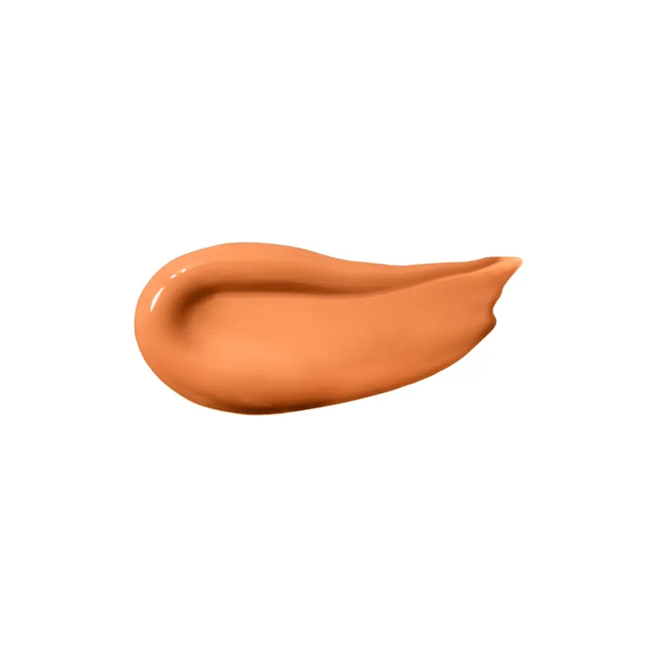 A smear of orange-brown cream on a white background.