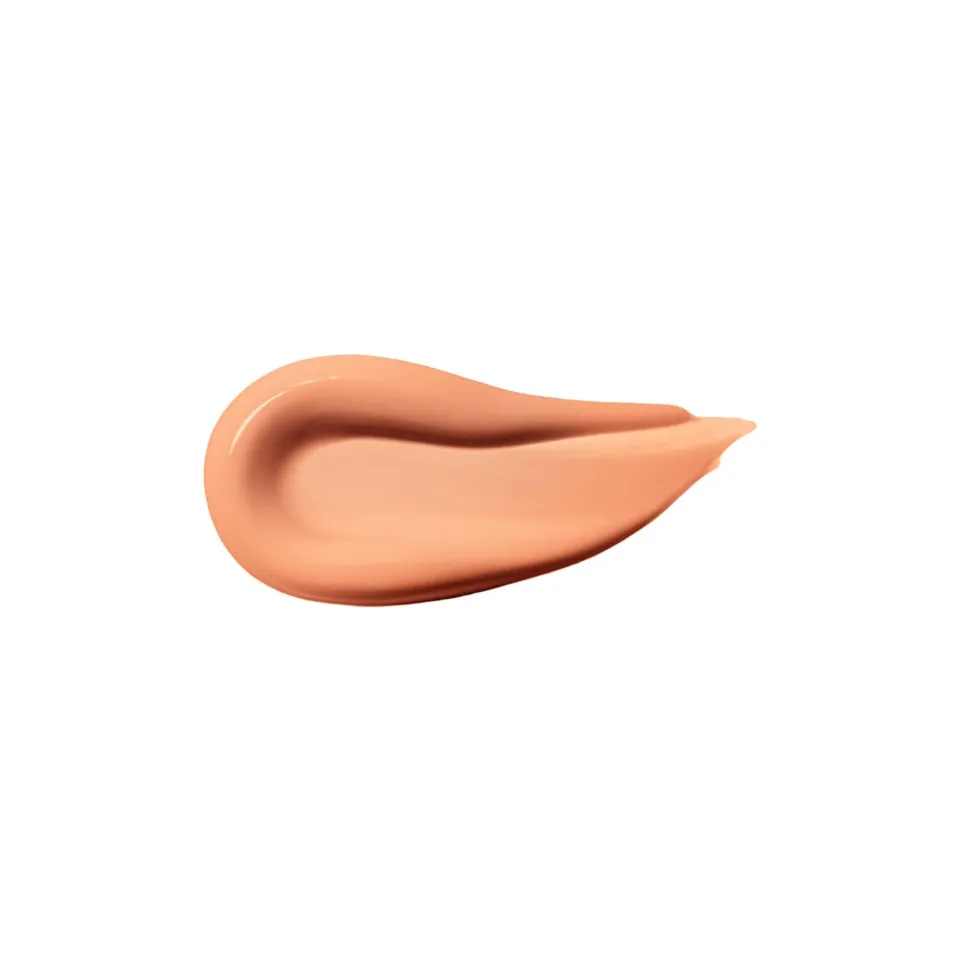 Peach-coloured cream smear on white background.