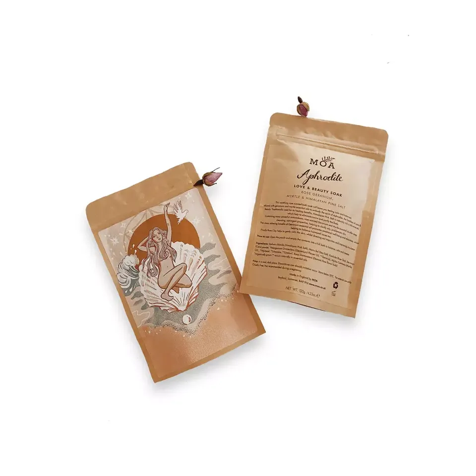 Two brown pouches of MOA Aphrodite Love & Beauty Soak with floral design and text.