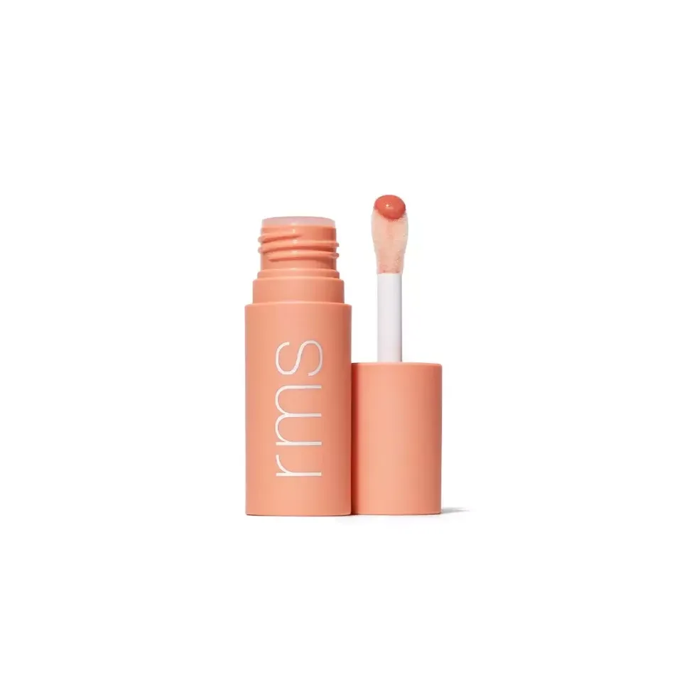 Peach-coloured lip gloss with "rms" text, open with applicator wand.