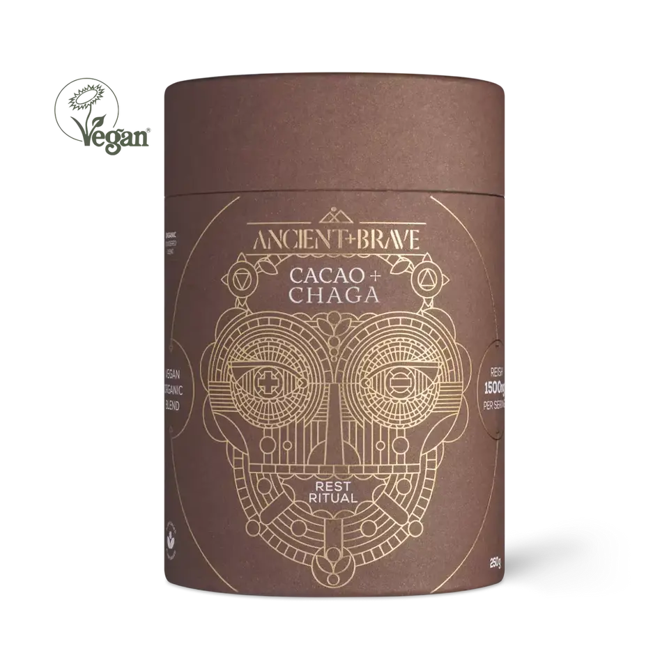 Brown cylindrical container with gold geometric design, labelled "Ancient + Brave Cacao + Chaga".
