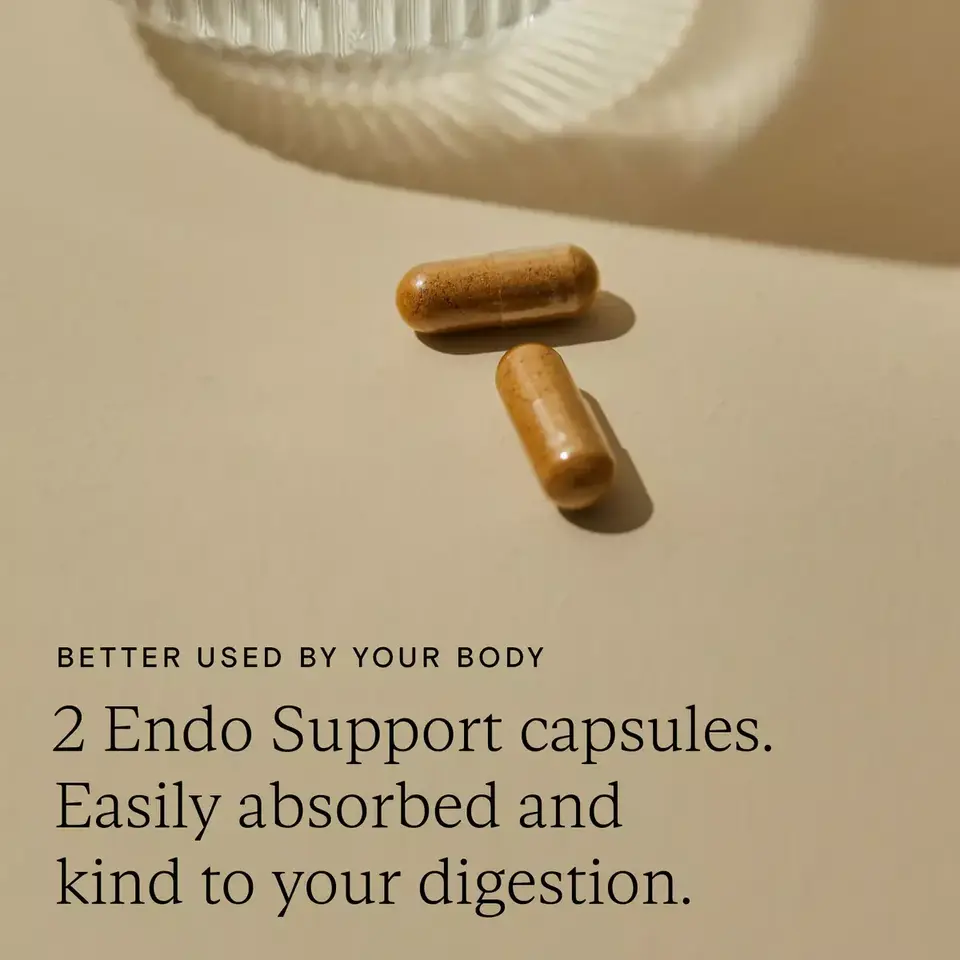 Two brown capsules on a beige surface with text about digestion benefits.