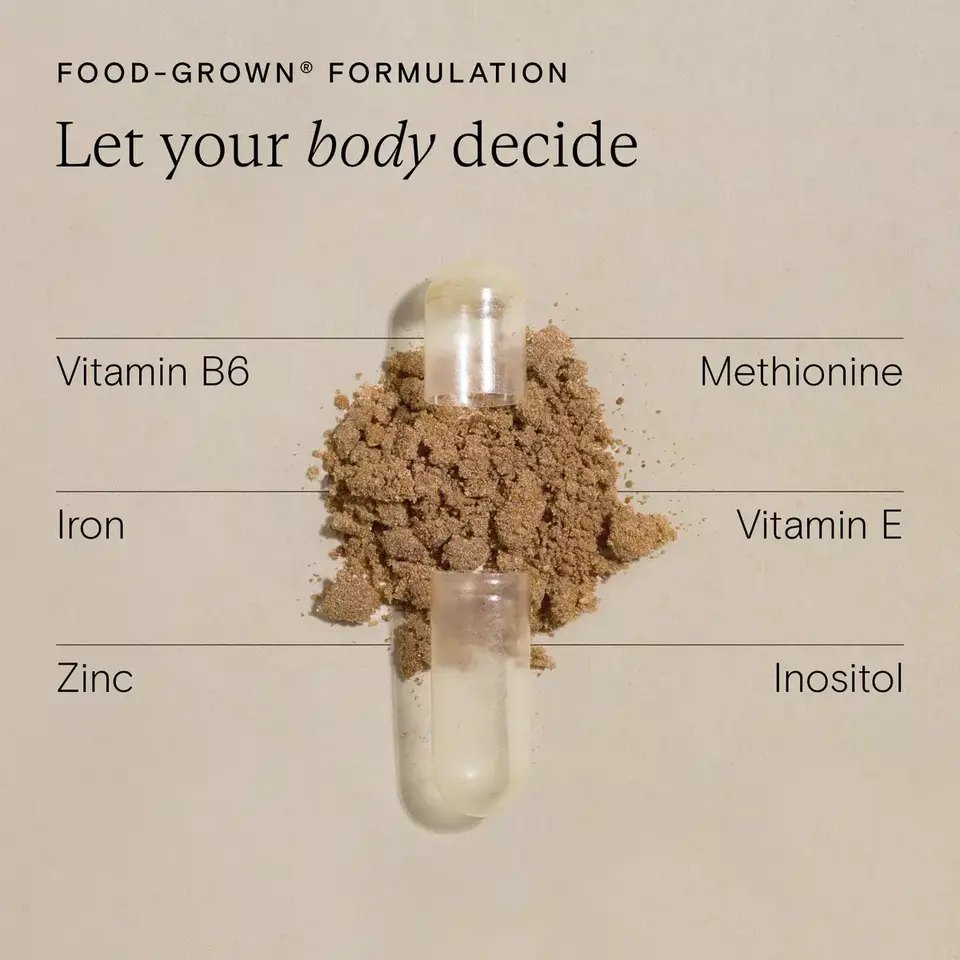 Open capsule with brown powder, labelled nutrients: Vitamin B6, Iron, Zinc, Methionine, Vitamin E, Inositol.