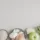 Assorted ingredients on plates: garlic, onion, apple, asparagus, oats, and rice on a light background.
